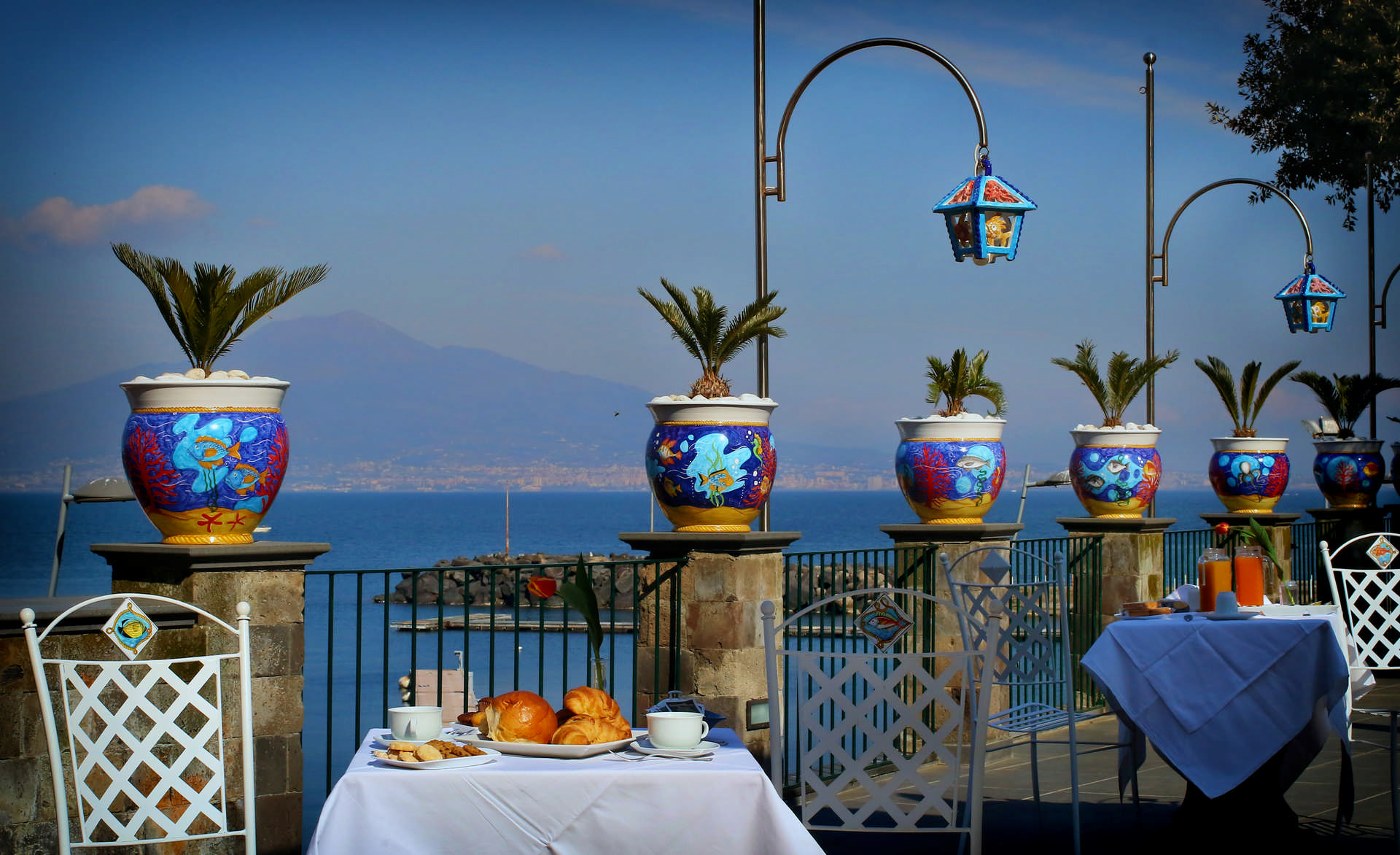 Villa De Luca — breakfast terrace with Vesuvius across the bay