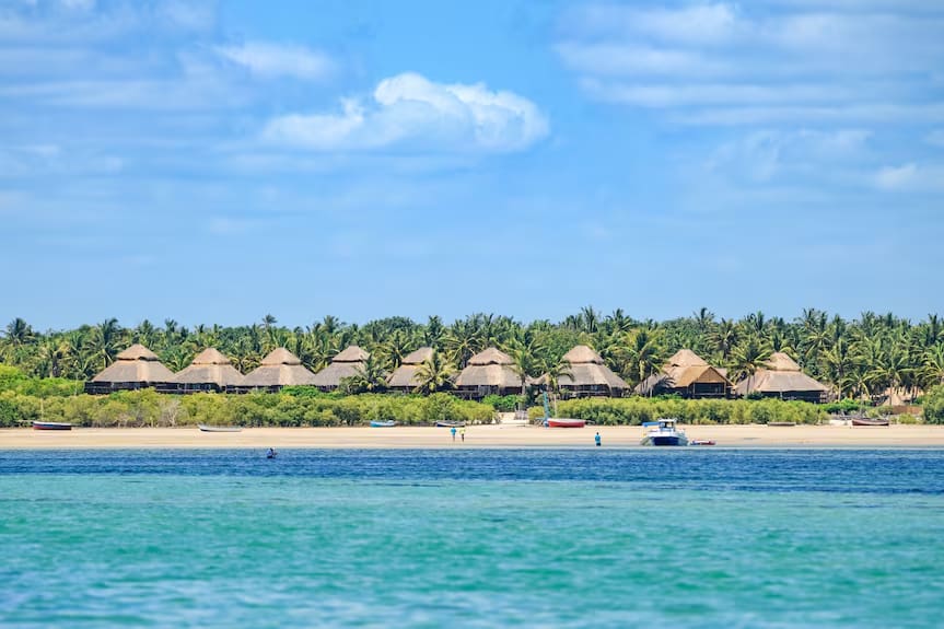 Ocean Pearl Beach Lodge Mozambique — thatched bungalows on a white sand beach